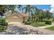Charming single-story home boasts mature landscaping, a tile roof, and a brick driveway at 7717 Us Open Loop, Lakewood Ranch, FL 34202