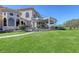 Stunning home exterior featuring a spiral staircase and expansive lawn, perfect for outdoor living at 7717 Us Open Loop, Lakewood Ranch, FL 34202