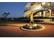 Beautiful exterior view of the golf club featuring a statue and a circular brick pathway at twilight at 7717 Us Open Loop, Lakewood Ranch, FL 34202