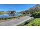 Scenic view of a golf course with a tranquil pond and fountain feature under a clear blue sky at 7717 Us Open Loop, Lakewood Ranch, FL 34202