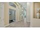 Spacious hallway features wood floors, arched doorways, and decorative columns at 7717 Us Open Loop, Lakewood Ranch, FL 34202