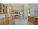 Close up of island with granite counters, stainless appliances and light wood cabinets at 7717 Us Open Loop, Lakewood Ranch, FL 34202