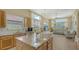 Kitchen area has granite counters, stainless appliances, and large windows bringing in natural light at 7717 Us Open Loop, Lakewood Ranch, FL 34202