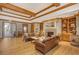 Inviting living room featuring hardwood floors, a fireplace, comfortable seating, and tasteful decor at 7717 Us Open Loop, Lakewood Ranch, FL 34202
