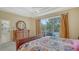 Relaxing main bedroom features an outdoor view, hardwood floors, and a large dresser at 7717 Us Open Loop, Lakewood Ranch, FL 34202