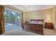 Main bedroom is spacious with lanai access, and boasts soft carpets and neutral paint at 7717 Us Open Loop, Lakewood Ranch, FL 34202