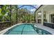 Beautiful screened-in pool provides a private backyard retreat with lush landscaping at 7717 Us Open Loop, Lakewood Ranch, FL 34202