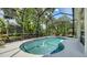 Serene screened pool with lush greenery creating a private backyard oasis at 7717 Us Open Loop, Lakewood Ranch, FL 34202