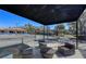 Exterior of a tennis court lounge area with ample seating and views of the tennis court at 7717 Us Open Loop, Lakewood Ranch, FL 34202