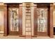 Wine cellar features custom storage for an extensive collection, with a ladder for easy access at 7717 Us Open Loop, Lakewood Ranch, FL 34202