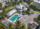 Aerial view of a beautiful community with a large swimming pool, clubhouse, and well-manicured landscaping at 7840 34Th Ave W # 303, Bradenton, FL 34209