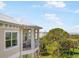Balcony view of the lawn, trees, and other buildings at 7840 34Th Ave W # 303, Bradenton, FL 34209