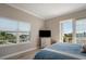 A relaxing bedroom featuring hardwood floors, television and a nice view from the window and the balcony at 7840 34Th Ave W # 303, Bradenton, FL 34209