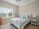 Relaxing bedroom featuring a nautical theme, a ceiling fan, and natural light from the large window at 7840 34Th Ave W # 303, Bradenton, FL 34209