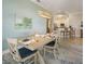 Elegant dining area with a stylish light fixture, table set for service and access to the kitchen at 7840 34Th Ave W # 303, Bradenton, FL 34209