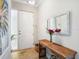 Inviting foyer featuring a stylish wooden table, decorative mirror, and beachy artwork at 7840 34Th Ave W # 303, Bradenton, FL 34209