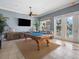 Entertaining game room with a billiards table, TV, and access to an outdoor pool area at 7840 34Th Ave W # 303, Bradenton, FL 34209