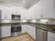 Bright kitchen featuring stainless steel appliances, granite countertops, and white cabinetry at 7840 34Th Ave W # 303, Bradenton, FL 34209