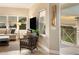 Inviting living room featuring cozy seating, a TV, a window with a view and access to a balcony at 7840 34Th Ave W # 303, Bradenton, FL 34209