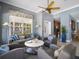 Inviting living room with comfortable seating, ceiling fan, and a large window, showcasing a stylish and relaxed atmosphere at 7840 34Th Ave W # 303, Bradenton, FL 34209