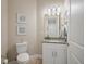 Neutral colored powder room with a granite countertop, and framed wall art at 7840 34Th Ave W # 303, Bradenton, FL 34209