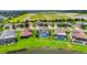 Aerial view of homes featuring screened-in pools, lush green lawns, and tranquil waterfront property at 7930 111Th Ter E, Parrish, FL 34219