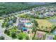 Aerial view of the neighborhood community featuring a pool, playground, basketball court, and nearby ponds and houses at 7930 111Th Ter E, Parrish, FL 34219