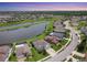 Beautiful aerial view of homes and community with lake, lush greenery, and blue skies at 7930 111Th Ter E, Parrish, FL 34219
