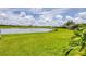 Lush backyard with a peaceful lake view, offering a serene and private outdoor space at 7930 111Th Ter E, Parrish, FL 34219