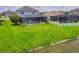 A spacious backyard with a screened-in pool and well-maintained lawn stretching to the waterfront at 7930 111Th Ter E, Parrish, FL 34219
