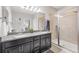 Beautiful bathroom featuring double sinks with granite counters and a glass door shower at 7930 111Th Ter E, Parrish, FL 34219