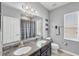 Bathroom featuring dual sinks with a granite countertop and a shower with a curtain at 7930 111Th Ter E, Parrish, FL 34219