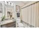 Bathroom featuring granite vanity top with under-mount sink and decorative shower curtain at 7930 111Th Ter E, Parrish, FL 34219