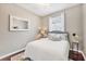 Bright bedroom with a plush bed, natural light from the window, and a clean, serene ambiance for relaxation at 7930 111Th Ter E, Parrish, FL 34219