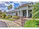 Community clubhouse entrance with a well-kept lawn, shrubs, brick walkway and manicured palm trees at 7930 111Th Ter E, Parrish, FL 34219