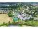 Overhead capture of a community pool, basketball court, parking and recreation area with lush green trees at 7930 111Th Ter E, Parrish, FL 34219