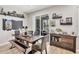 Inviting dining room featuring a rustic wood table, bench seating, and sliding glass doors to the outdoor living area at 7930 111Th Ter E, Parrish, FL 34219