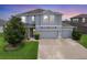 Beautiful two-story home featuring a three-car garage and manicured lawn at 7930 111Th Ter E, Parrish, FL 34219