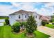 Beautiful exterior view of a two-story home with lush landscaping, and a well-manicured lawn at 7930 111Th Ter E, Parrish, FL 34219