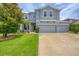 Inviting two-story home featuring a well-manicured lawn, three-car garage, and an elegant entrance at 7930 111Th Ter E, Parrish, FL 34219