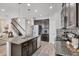 Open kitchen featuring a large island, modern appliances, and an adjacent staircase at 7930 111Th Ter E, Parrish, FL 34219