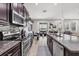 Bright kitchen with stainless steel appliances and open layout to the dining area and living room at 7930 111Th Ter E, Parrish, FL 34219