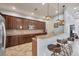 Well-equipped kitchenette with granite countertops, wooden cabinets, stainless steel appliances and stylish pendant lighting at 7930 111Th Ter E, Parrish, FL 34219