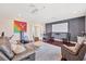 Living room featuring a projector screen, comfortable seating, and a versatile space for entertainment and fitness at 7930 111Th Ter E, Parrish, FL 34219