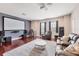 Spacious living room with a projector screen, comfortable seating, and modern audio system, perfect for entertainment at 7930 111Th Ter E, Parrish, FL 34219