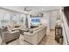 Bright living room with large windows, comfortable seating, and access to the staircase at 7930 111Th Ter E, Parrish, FL 34219