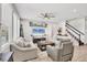 Spacious living room featuring neutral furniture, stylish decor, and staircase access at 7930 111Th Ter E, Parrish, FL 34219