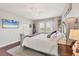 A bright main bedroom featuring hardwood floors and a decorative bed with modern entertainment at 7930 111Th Ter E, Parrish, FL 34219