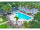 Aerial view of a beautiful pool area featuring lounge chairs and lush landscaping perfect for relaxation at 7930 111Th Ter E, Parrish, FL 34219