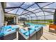 Inviting screened pool area with comfortable lounge seating and beautiful lake views at 7930 111Th Ter E, Parrish, FL 34219